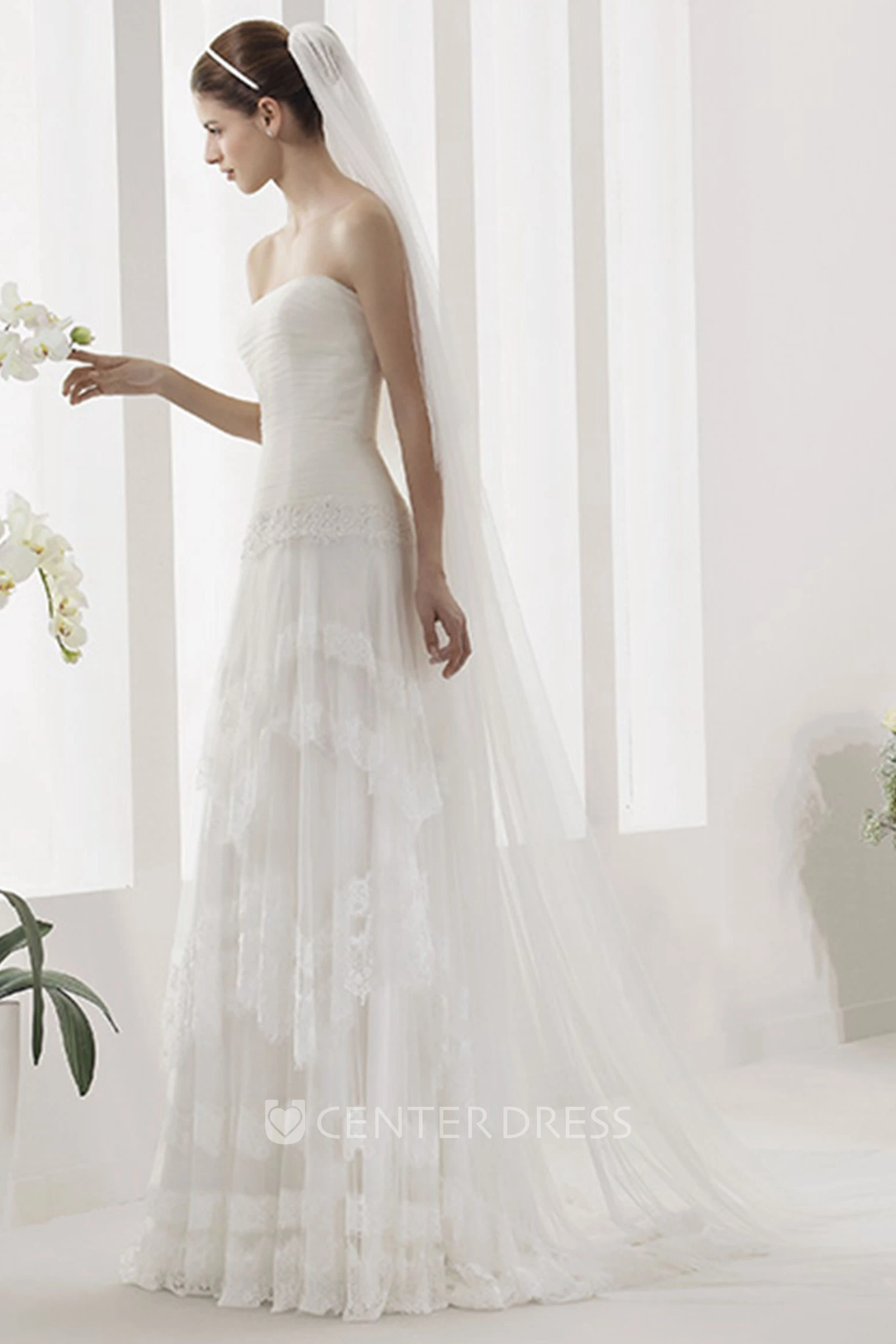 Strapless Tulle Gown With Ruched Bodice And Drop Jewel Waist
